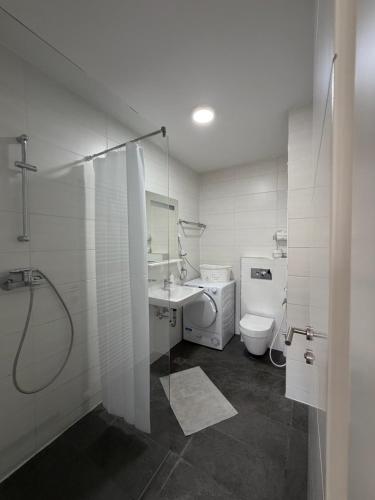 a bathroom with a shower and a sink and a toilet at Panamera Luxury Apartment Ilidža in Sarajevo