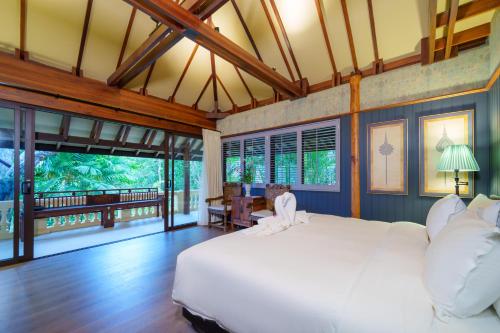 a bedroom with a large white bed and large windows at Ladylagoon Luxury Multi-Purpose Private Beachfront Villas Koh Samui in Koh Samui