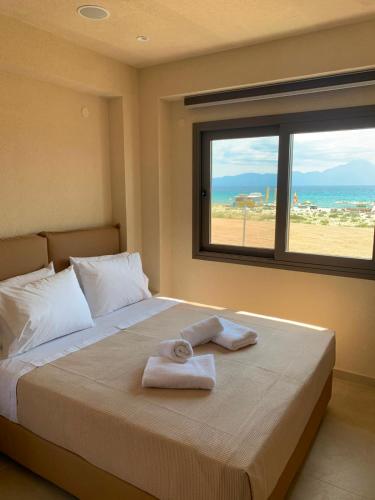 a bedroom with a bed with two towels on it at THALASSA BOUTIQUE HOTEL in Sarti