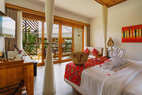a bedroom with a bed and a desk in a room at Anaya Hotel Zanzibar in Pwani Mchangani