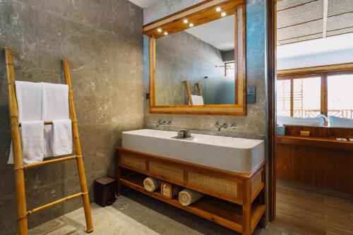 a bathroom with a sink and a mirror at Anaya Hotel Zanzibar in Pwani Mchangani