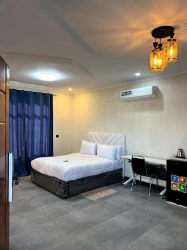 a bedroom with a bed and a desk and a bed sidx sidx sidx at Ravens nests lodge in Livingstone