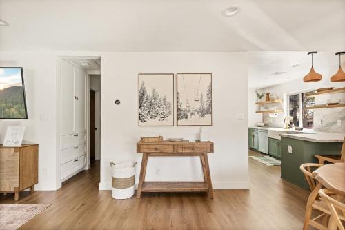 a kitchen with white walls and a wooden table at Modern Hideaway in Big Bear in Big Bear City