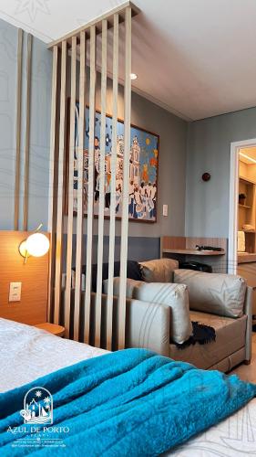 a bedroom with two beds and a crib at Refúgio Azul de Porto in Porto De Galinhas