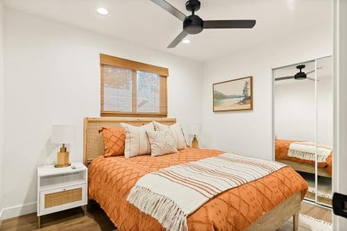 a bedroom with a bed and a ceiling fan at Modern Hideaway in Big Bear in Big Bear City