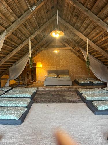 an attic room with several mattresses on the floor at Grandma's Attic in Saraiķi