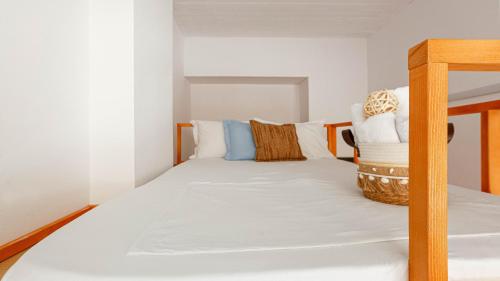a bedroom with a bunk bed with white sheets at Mini Stylish - Central Studio w kitchen in Himare