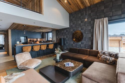 a living room with a couch and a table at Les Chalets de l'Observatoire in Megève
