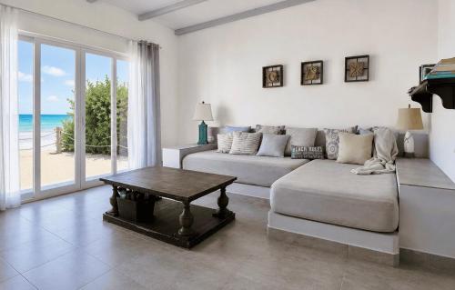a living room with a couch and a table at Sandy Feet House in Puerto Villamil