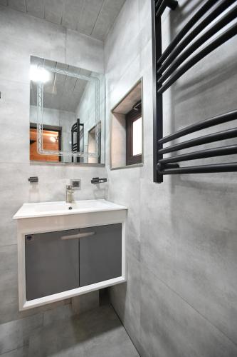 a bathroom with a sink and a mirror at ARBAT house LUXURY in Arbatʼ