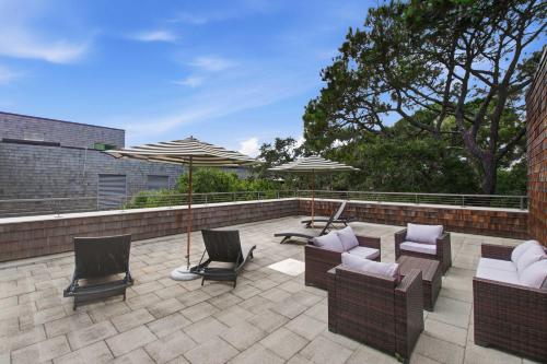a patio with chairs and umbrellas on a patio at 2479 Shipwatch in Kiawah Island