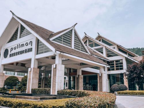 a building with a sign in front of it at Pullman Zhangjiajie Hotel in Zhangjiajie