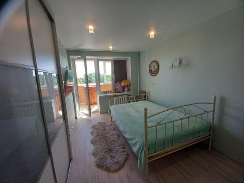 a bedroom with a bed and a mirror at Amber Beach Apartment in Narva-Jõesuu
