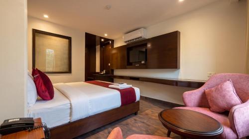 a hotel room with a bed and a table and a chair at The Chapter Hotel, Vasant Kunj in New Delhi