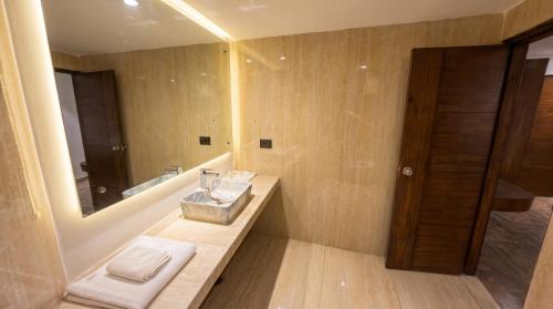 a bathroom with a sink and a mirror at The Chapter Hotel, Vasant Kunj in New Delhi