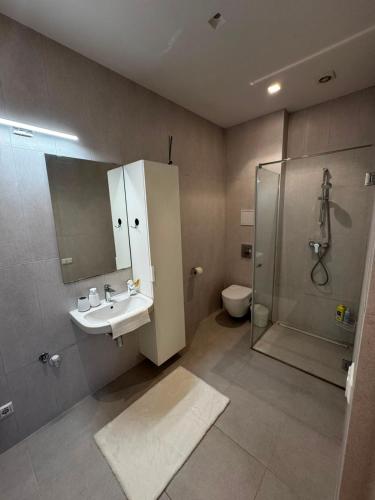 a bathroom with a sink and a shower at Cozy corner89, private parking in Valmiera