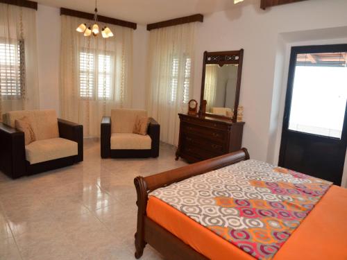 a bedroom with a bed and a dresser and a mirror at Villa Marinero in Ulcinj