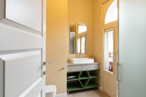 a bathroom with a sink and a mirror at VILLA UGO b & b in Salsomaggiore Terme