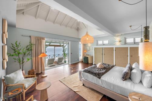 a bedroom with a bed and a living room at BijBlauw in Willemstad