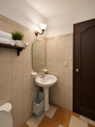 a bathroom with a sink and a mirror at Hotel Valeria in Granada