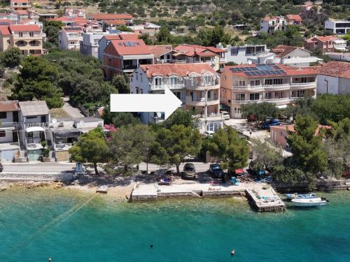 an aerial view of a town with a dock in the water at Open Sea Apartmani in Grebaštica