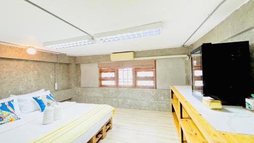 a room with two beds and a flat screen tv at The Yak Cozy Chiang Mai in Chiang Mai