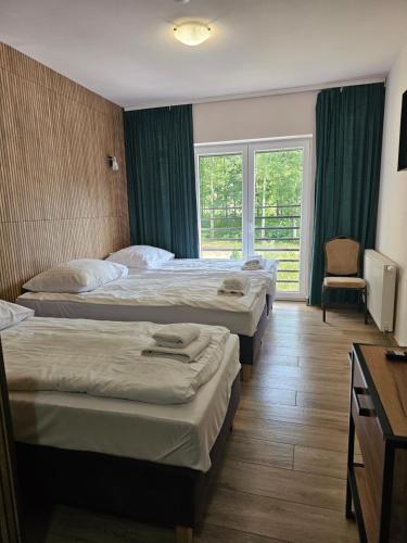 a hotel room with two beds and a window at JURAJSKI OLSZTYN in Olsztyn
