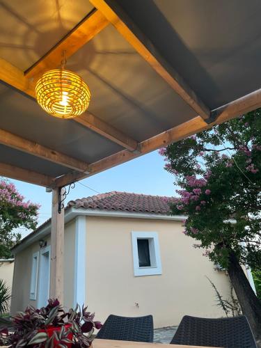 a patio with awning and a table and chairs at Anabelis studios & apartments in Katelios