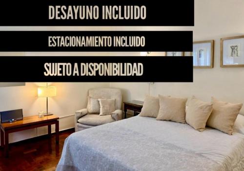 a bedroom with a bed and a chair at Hotel Villa Inés Mendoza in Mendoza