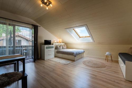 a bedroom with a bed and a window in a room at Ferienwohnung Kampenwand in Bad Endorf