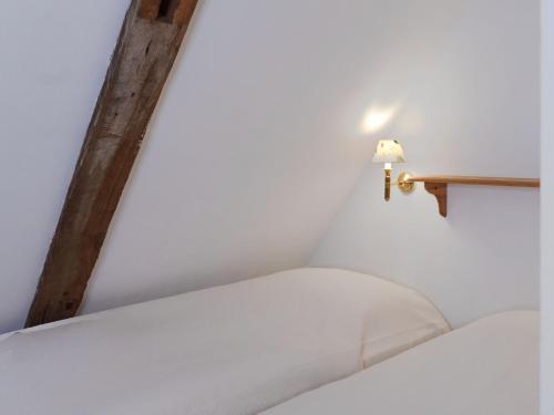 a bed in a room with a cross on the wall at Ferienwohnung Hasenkate I - Boldevitzer Rügenkaten in Parchtitz