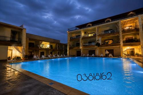 a large swimming pool in front of a building at chalet in saint remon in Al Bāţiyah