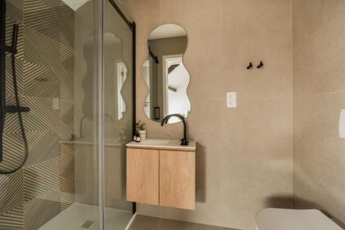 a bathroom with a sink and two mirrors at Leeuwenhof Suites in Antwerp