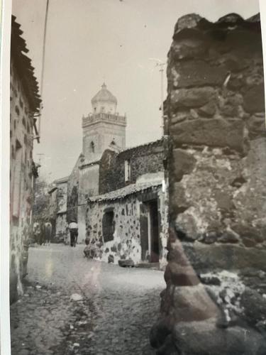 a black and white photo of a building with a tower at Prendas Paulilatino in Paulilatino