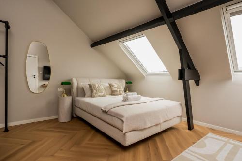 a bedroom with a bed and a large window at Leeuwenhof Suites in Antwerp