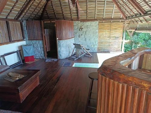 a room with a bed and a wooden floor at Manta be à Nosy Komba in Ampangorinana