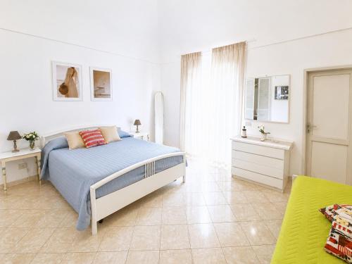 a white bedroom with a bed and a bathroom at Maridea - Turritella in Ponza