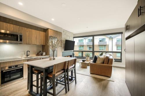 a kitchen with a table and chairs in a room at Kindred Resort, A RockResort in Keystone