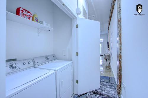 a white washer and dryer in a white laundry room at The Stallion #101 - 1BD Modern Loft with Private Patio - Walk to various attractions in Memphis