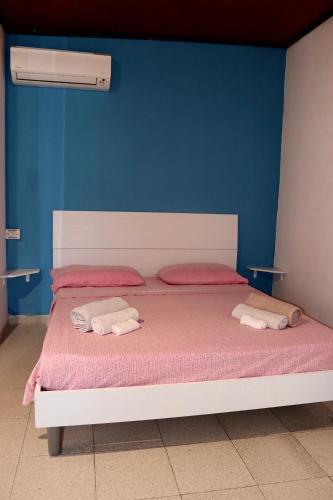 a bedroom with a bed with two towels on it at Pantera Rosa Village in Scalea