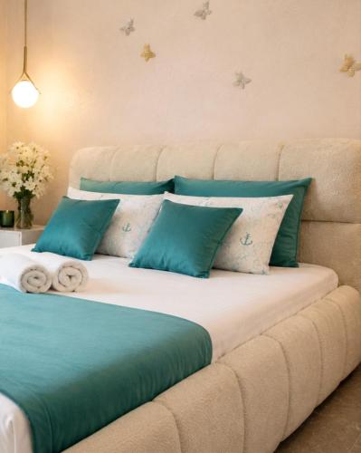 a bed with blue and white pillows on a couch at Ap Blessedplace Rîșcani-New Bldg in Chişinău