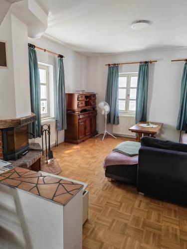 a living room with a couch and a table at Center Grič - sobe, apartma in Sveta Trojica v Slovenskih Goricah