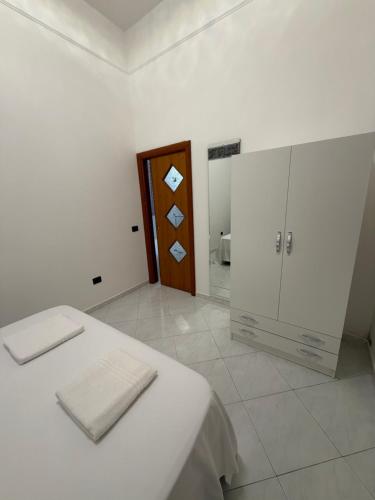 a white room with a bed and a wooden door at Vittoria & Celeste in Cervino