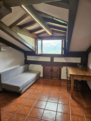 a room with a couch and a table and a window at Apartamentos Las Rocas de Brez in Brez