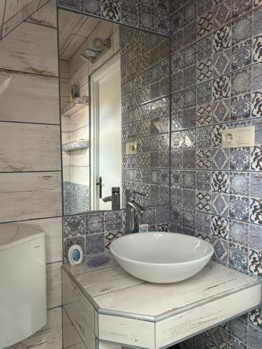 a bathroom with a sink and a mirror at PEP Apartman in Balatonlelle