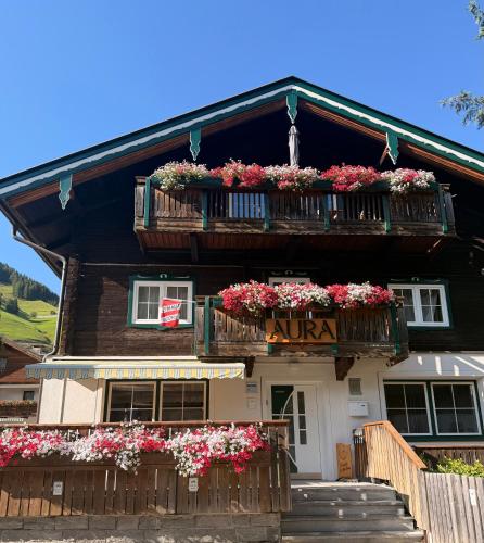a building with flower boxes and balconies on it at AURA Bed & Breakfast in Sankt Jakob in Defereggen