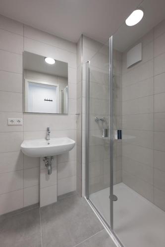 a bathroom with a sink and a shower at smart studios - by kalm stay in Munich