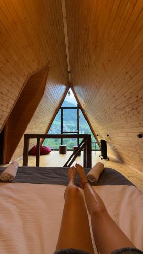 a person laying on a bed in a room at Cottage TowerView in Mestia in Mestia