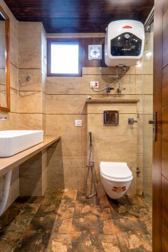 a bathroom with a toilet and a sink at Hotel Windsor in Shimla