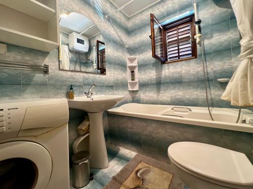 a bathroom with a sink and a toilet and a tub at Vodice Center Apartments in Vodice